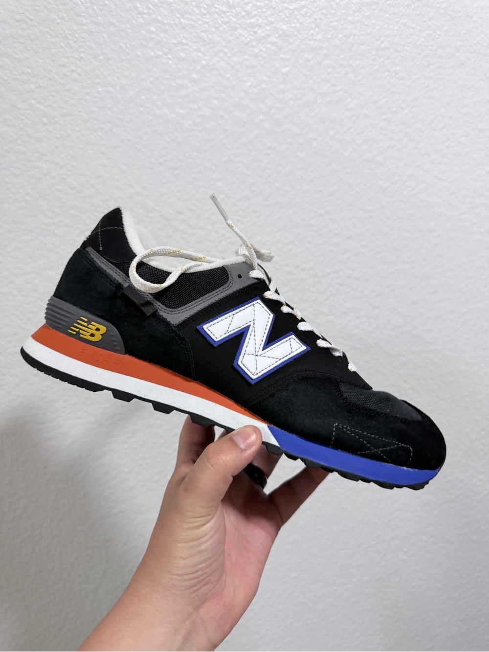 New Balance Men's Black Suede Sneaker with Orange and Blue Accents